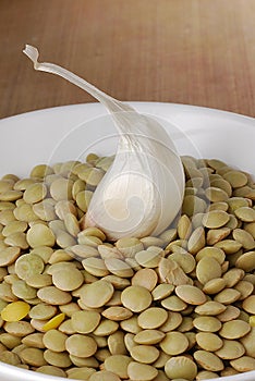 Garlic clove on bed of dried peas