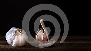 A garlic and cloves of garlic on a wooden table