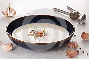 Garlic cream soup on rustic background