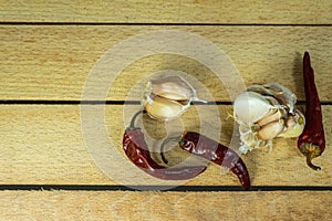 Garlic and dry chili pepper on the background of a wooden table. fresh garlic and dried chili peppers. Dried red pepper