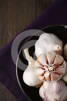 Garlic and garlic cloves on dark backround