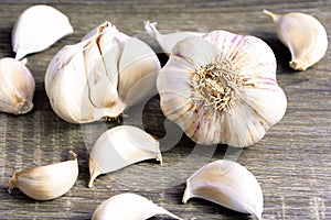 Garlic and garlic cloves on a wooden cutting board