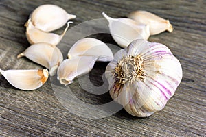 Garlic and garlic cloves on a wooden cutting board