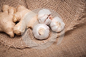 Garlic and ginger close up on fabric burlap