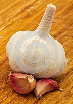 Garlic. head and cloves of purple garlic isolated on a wooden board