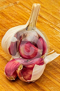 Garlic. head and cloves of purple garlic isolated on a wooden board