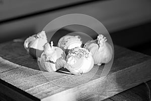 Garlic heads on a wooden cutting board