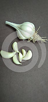 Garlic pieces on brown background