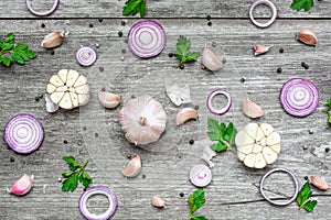 Garlic, red onion, parsley and pepper on rustic wooden background