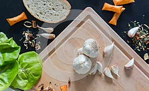 Garlic and seasonings on wooden cut desk