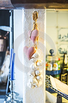 Garlic and textil heart decorations in the kitchen