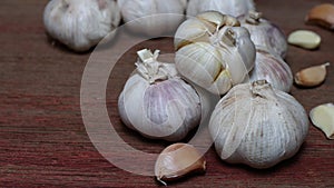 Garlic on wooden background, copy space.