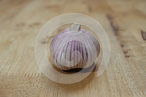 Garlics and unions on the wooden table