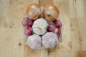 Garlics and unions on the wooden table