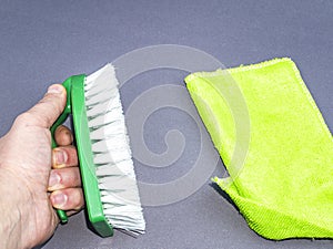 Garment brush with white bristles in hand