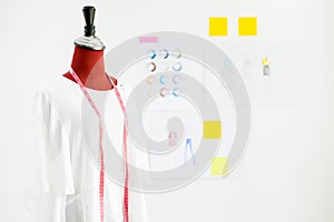 garment design on mannequin Red dummy with measuring tape in tai