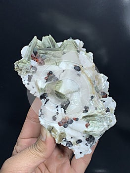 Garnet with tourmaline schorl muscovite mica albite mineral specimen crystal