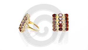 Garnet with white topaz Jewel or gems ring on white background with reflection. Collection of natural gemstones accessories.