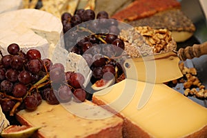 Garnished cheese plate with grapes