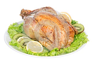 Garnished roasted thanksgiving chicken on a plate decorated with