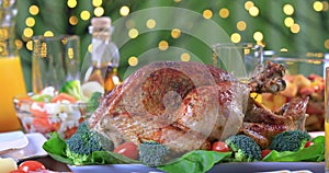 Garnished roasted turkey on festive table closeup