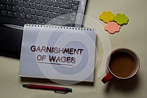 Garnishment of Wages write on a book isolated on office desk photo
