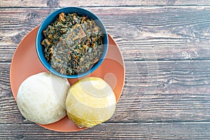 Garri and Pounded Yam served with Efo Riro Vegetable Soup photo