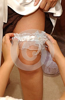 Garter on the bride`s leg