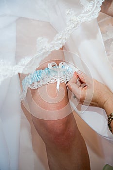 Garter on leg of bride photo