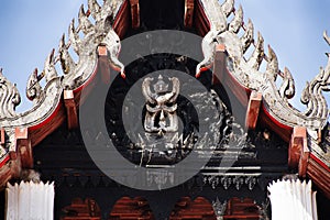 Garuda or Galon or Nan Belu deity angel statue legendary bird or bird creature on roof ancient antique ordination halls or old photo