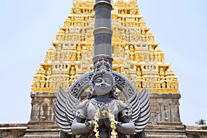 Garuda, the vehicle of the Hindu god Vishnu facing the Chennakesava temple, Belur, Karnataka. East Gopura, tower over entrance, is