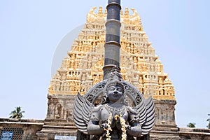 Garuda, the vehicle of the Hindu god Vishnu facing the Chennakesava temple, Belur, Karnataka. East Gopura, tower over entrance, is