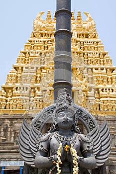 Garuda, the vehicle of the Hindu god Vishnu facing the Chennakesava temple, Belur, Karnataka. East Gopura, tower over entrance, is