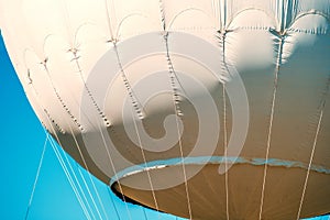 Gas balloon cables over the blue