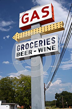 Gas, Beer and Grocery Sign with Blue Sky and Clouds in Background