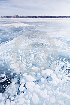 Gas bubbles in ice. Baikal lake. Winter landscape