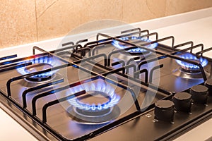 Gas burner on black modern kitchen stove