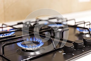 Gas burner on black modern kitchen stove