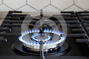 Gas burner on black modern kitchen stove. kitchen gas cooker with burning fire propane gas