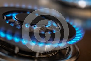 The gas burner burns with the blue flame of a propane butane stove in a home kitchen or hotel restaurant