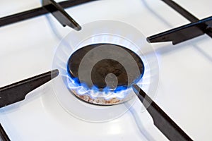 Gas burner flame close up. Can be a source of fire or explosion. Household gas stove