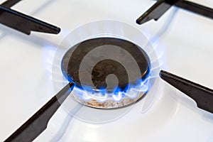 Gas burner flame close up. Possible leakage and gas poisoning. Household gas stove