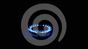 Gas Burner On, Glowing with Blue Flame, at Night in Kitchen. Close-up