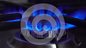 The gas burner on the stove burns. The flame is blue.