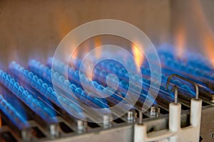 Gas burning in a heating appliance. A stainless steel burner heats a copper heat exchanger