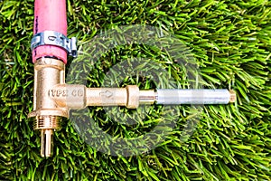 Gas bypass regulator connected to plastic pipes, on grass