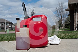 Gas can with fuel stabilizer next to it for long term storage in a lawnmower or snow blower