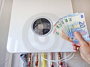 Gas central heater of residential house and euro currency, energy efficiency concept â€“ the cost of natural gas and electricity