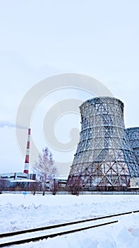 Gas combined heat and power plant with huge pipes, smoke, steam, power stations