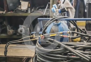 Gas cylinder, hose and blowtorch at the factory